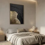 Textured abstract hand-painted canvas in charcoal black and gold leaf, contemporary bedroom setting