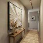 Textured abstract hand-painted canvas with radiating golden and cream brushstrokes, contemporary hallway