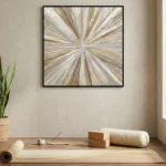 Gestural abstract hand-painted canvas with radiating brushstrokes in cream, gold, and taupe tones, contemporary workspace