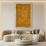 Textured abstract hand-painted canvas in golden ochre and warm mustard tones, contemporary living space