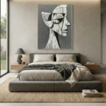 Contemporary hand-painted canvas featuring abstract geometric head profile in monochrome grays and cream, modern bedroom setting