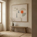 Minimalist abstract hand-painted canvas with geometric shapes in cream, sage, and striking orange accents, contemporary entryway