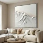 Textured minimalist hand-painted canvas depicting snow-capped mountain peaks in monochromatic white and grey tones, contemporary living space