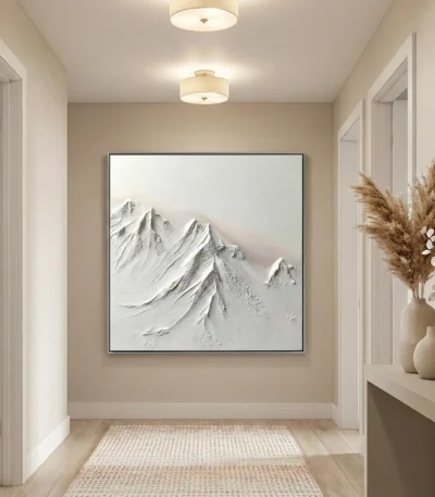 Textured monochrome hand-painted canvas depicting snow-capped mountain peaks in layered white and gray tones, contemporary entryway