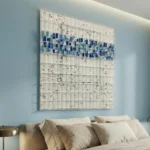 Textured abstract hand-painted canvas with blue and teal gestural marks on cream speckled ground, contemporary bedroom