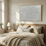 Textured hand-painted canvas depicting a solitary tree with delicate falling leaves in monochromatic white and silver tones, contemporary bedroom