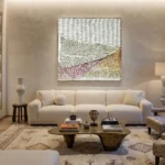 Textured landscape hand-painted canvas with layered rolling hills in cream, mauve, and golden tones, contemporary living space