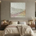 Textured abstract landscape hand-painted canvas in layered cream, taupe, and dusty rose tones, contemporary bedroom