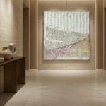 Textured landscape hand-painted canvas in layered greens, purples, and sandy tones, contemporary gallery space