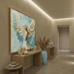 Textured abstract hand-painted canvas featuring ethereal white and cream wings with gestural brushstrokes in soft blue and gold tones, contemporary entryway