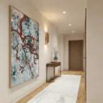 Textured abstract hand-painted canvas with layered rust and teal patterning over cream and blue tones, modern entryway