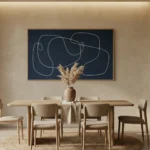 Minimalist abstract hand-painted canvas with flowing line gestures in cream and navy, contemporary dining space