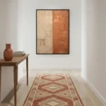 Textured abstract hand-painted canvas in terracotta and cream tones with layered geometric divisions, contemporary hallway
