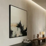 Abstract expressionist hand-painted canvas in monochrome blacks, creams and grays with gestural brushstrokes, modern living space