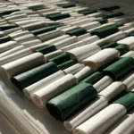 Textured hand-painted canvas in cream and forest green rolled samples, contemporary studio display