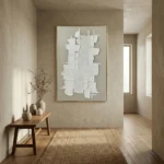 Textured abstract hand-painted canvas with layered white geometric forms and curved linear patterns in cream tones, contemporary entryway