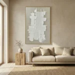Textured abstract hand-painted canvas with layered white geometric forms and curved linear patterns in cream and ivory, contemporary living space