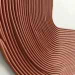 Contemporary textured wall art featuring undulating copper-toned ridges creating dimensional surface patterns, neutral interior