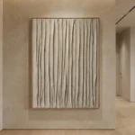 Textured abstract hand-painted canvas with vertical gestural brushstrokes in warm neutrals and cream tones, contemporary hallway