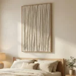 Textured minimalist hand-painted canvas with vertical gestural brushstrokes in cream and taupe tones, modern bedroom