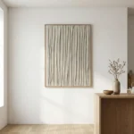 Minimalist hand-painted canvas with vertical tonal striations in soft beige and cream, contemporary interior