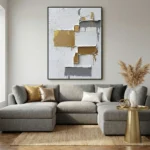 Textured abstract hand-painted canvas with layered gold, charcoal, and cream geometric blocks, contemporary living space