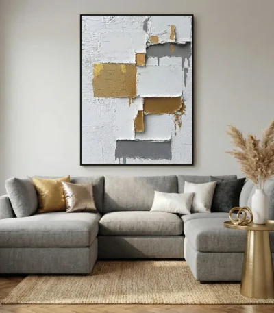 Textured abstract hand-painted canvas with layered gold, charcoal, and cream geometric blocks, contemporary living space