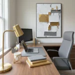 Textured abstract hand-painted canvas with layered gold, white, and charcoal brushstrokes, modern office setting