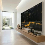 Gestural abstract painting with dramatic black and gold brushstrokes, hand-painted canvas in contemporary entryway