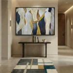Abstract hand-painted canvas with layered organic forms in cream, navy, gold, and charcoal tones, contemporary entryway