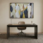 Contemporary abstract hand-painted canvas with flowing vertical forms in cream, gold, navy and charcoal, modern office setting