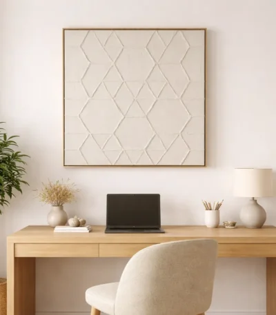 Textured minimalist hand-painted canvas featuring geometric diamond patterns in cream and taupe tones, contemporary workspace