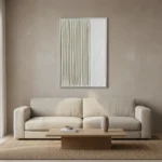 Minimalist hand-painted canvas with vertical linear striations in soft cream and white tones, contemporary living space