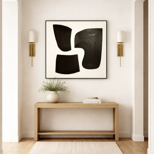 Minimalist abstract hand-painted canvas with bold black organic shapes on cream, contemporary entryway
