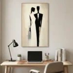 Minimalist hand-painted canvas depicting two silhouetted figures in black and neutral tones, contemporary workspace