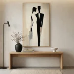 Minimalist hand-painted canvas depicting two silhouetted figures in black and cream tones, contemporary entryway