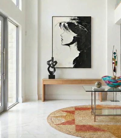 Monochromatic figurative hand-painted canvas depicting a profile portrait in bold black and white gestural strokes, contemporary entryway
