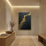 Textured abstract hand-painted canvas with black layered surface and gold leaf accents, contemporary minimalist space