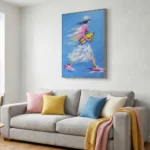 Gestural figurative hand-painted canvas depicting woman in flowing pink dress with yellow wings against vivid blue sky, contemporary living space