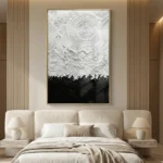 Textured abstract hand-painted canvas with concentric circular patterns in white and black, modern bedroom setting