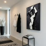 Abstract hand-painted canvas with bold black and white geometric shapes, contemporary entryway