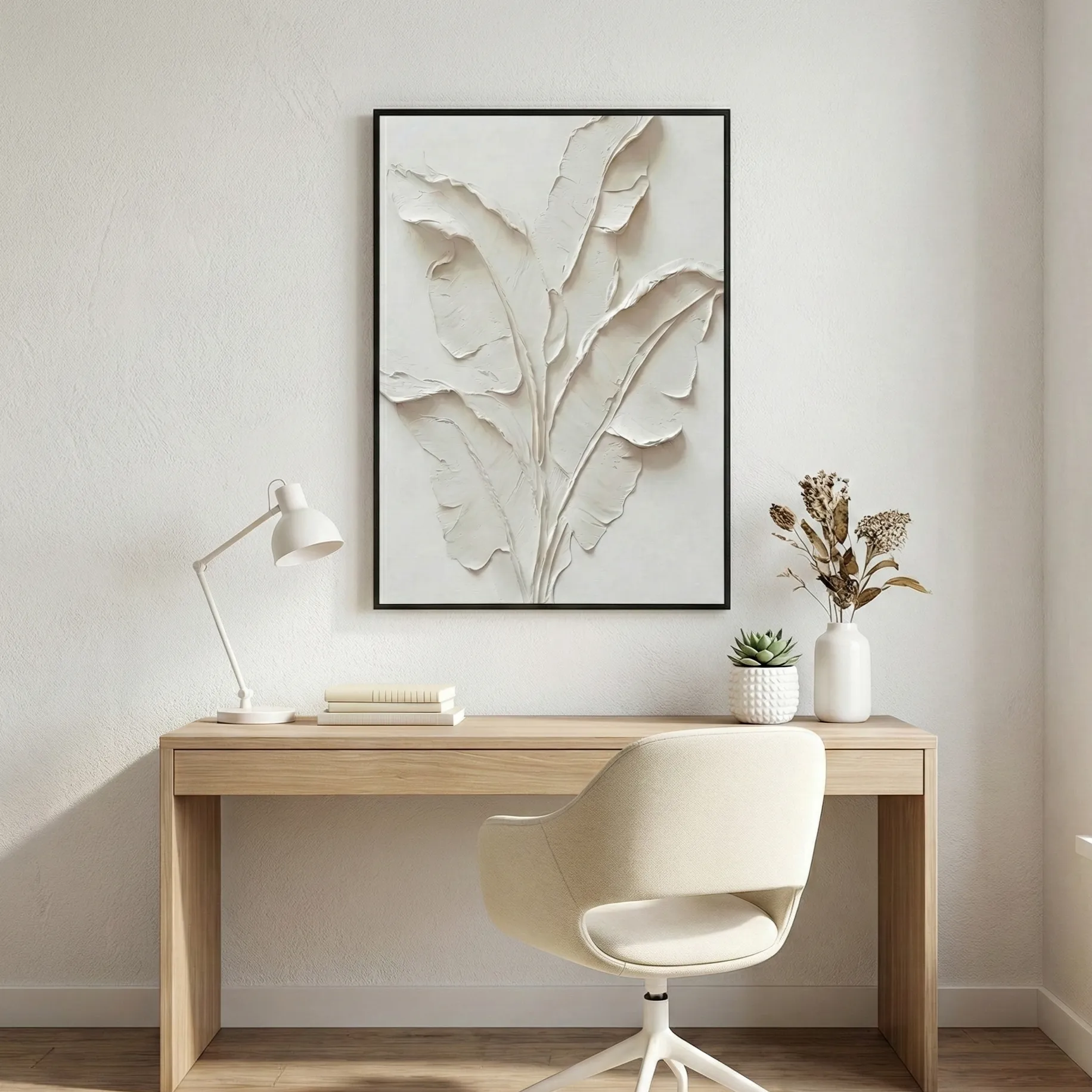 Monochrome Tropical Frond Minimalist Print (5) Textured minimalist hand-painted canvas depicting layered botanical leaves in soft cream and ivory tones, styled in contemporary workspace