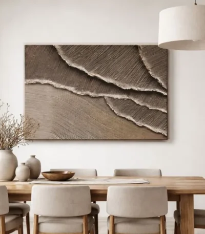 Textured abstract hand-painted canvas with layered cream and taupe brushstrokes suggesting ocean waves, contemporary dining space