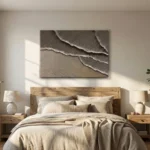 Textured abstract hand-painted canvas with layered torn paper effect in warm taupe and cream tones, modern bedroom