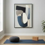 Minimalist abstract hand-painted canvas with layered geometric shapes in navy, charcoal, cream and taupe tones, contemporary studio setting