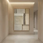 Textured abstract handcrafted canvas in layered cream and taupe tones, contemporary hallway setting