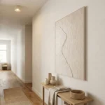Minimalist textured hand-painted canvas with organic curved line in warm neutrals, contemporary hallway