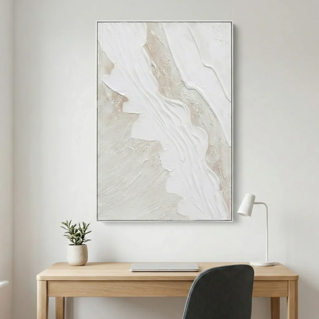 Textured abstract hand-painted canvas in cream, white and pale taupe with gestural brushwork, modern workspace