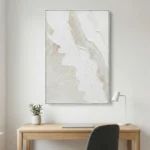 Textured abstract hand-painted canvas in cream, white and pale taupe with gestural brushwork, modern workspace