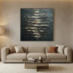 Textured abstract hand-painted canvas with layered metallic and charcoal brushstrokes in horizontal composition, contemporary living space